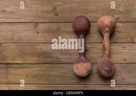 Old Dumbbells On Wooden Surface Stock Photo