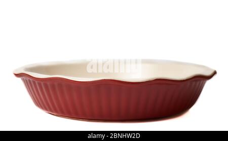 Round baking dish empty isolated on white background. Horizontal close-up red color. Not new. Stock Photo