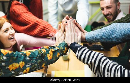 Young work team celebrating for new startup in creative office - Happy coworkers giving strength motivation - Focus on close-up hand - Co-working, bus Stock Photo