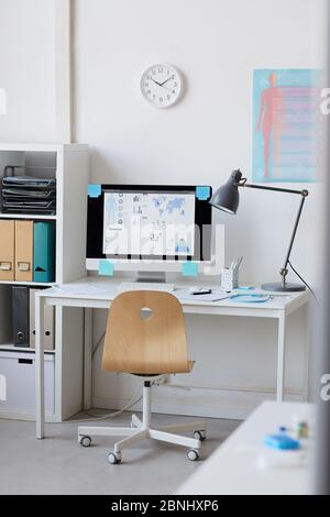 Image of computer monitor with online presentation on the screen on the table at office Stock Photo