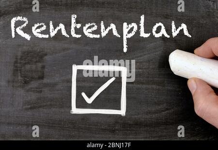 person writes the german word pension plan on a blackboard Stock Photo