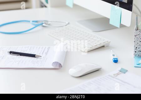 Close-up of medical card on the table with other medical supplies at the hospital Stock Photo