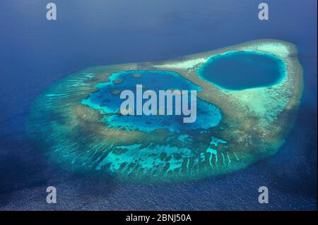 Aerial view of the coral reef which builds a lagoon in the atoll ...