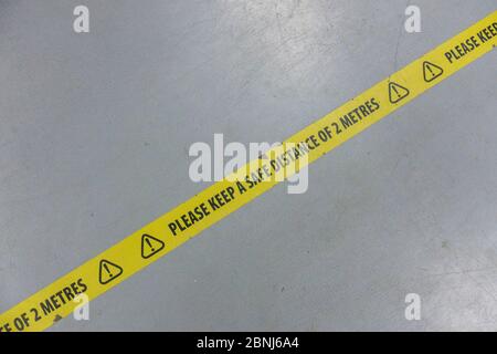 West Norwood, UK. 15th May, 2020. Social distancing tape, with the message 'Please Keep A Safe Distance Of 2 Metres' on the floor at a DIY superstore in South London. (photo by Sam Mellish / Alamy Live News) Stock Photo