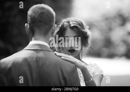 Fabulous young wedding couple posing in the park on the sunny day. Stock Photo