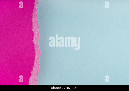 Torn ragged purple paper edges on blue background. Ripped cracked paper edge isolated with soft shadow. Paper piece torn edge. Copy space, frame, bann Stock Photo