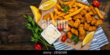 Crispy Fish Bites Snack Size. Deep Fried Pollock Fish Fingers with Tartar  Dipping Sauce Stock Photo - Alamy