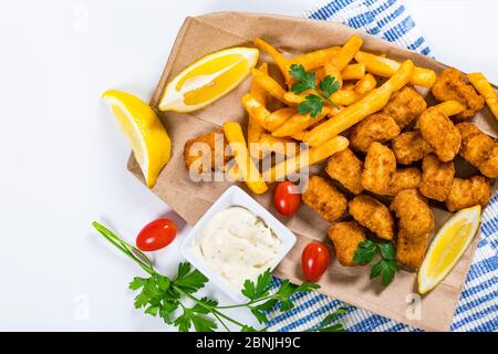Crispy Fish Bites Snack Size. Deep Fried Pollock Fish Fingers with Tartar  Dipping Sauce Stock Photo - Alamy