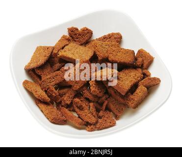 rye crackers, small dried pieces of bread with spices, delicious fast food isolated on white background Stock Photo