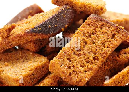 rye crackers, small dried pieces of bread with spices, delicious fast food isolated on white background Stock Photo