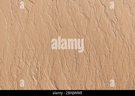 Patterns texture of sand left in the beach by receding tidal waters at the sea shore beach Stock Photo