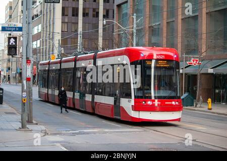 TTC (Toronto Transit Commission) street car westbound on Queen Street Stock Photo