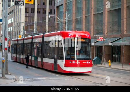 TTC (Toronto Transit Commission) street car westbound on Queen Street Stock Photo