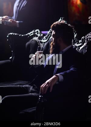 Man sitting with wine glass on vintage sofa Stock Photo