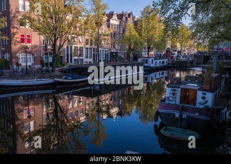 Amsterdam, Netherlands - April 2017: A shady corner on Amsterdam's canal Stock Photo