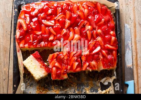 Sponge cake with lemon cream custard, strawberries and jelly, sliced Stock Photo