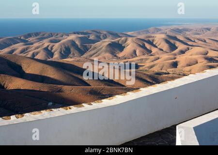 Observation deck over a barren hilly landscape with the ocean visible in background, Fuerteventura, Canary Islands, Spain