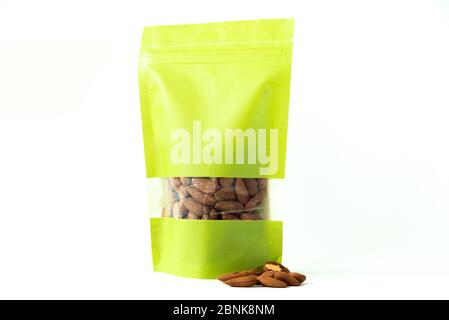 almond filled plain green paper doypack stand up eco friendly bag with window zipper on white background Stock Photo