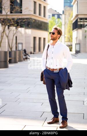 Man in a suit while the sun is shining, Frankfurt Main, Germany Stock Photo