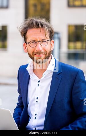man working outside in Frankfurt Main, Germany Stock Photo