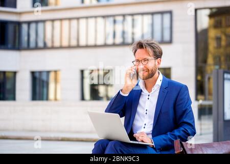 man working outside in Frankfurt Main, Germany Stock Photo