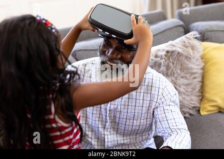 Senior African American man and his granddaughter Using vr headset Stock Photo