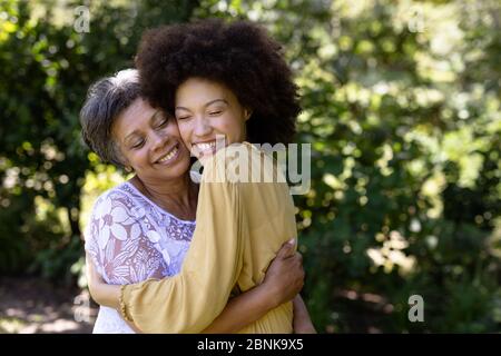 Senior mixed race woman and her daughter enjoying their time at a garden Stock Photo