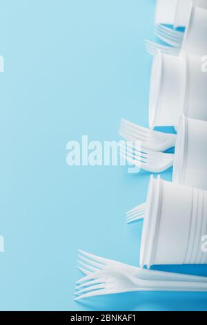 Dishes made of white plastic on a blue background. Free space. The view from the top Stock Photo