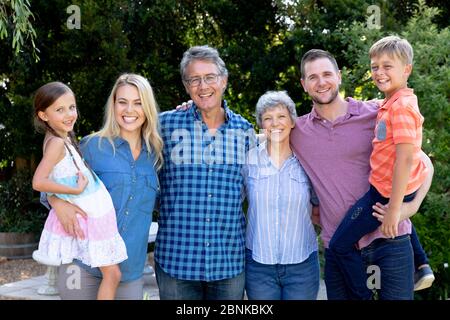 Three generation Caucasian family spending time in their garden Stock Photo