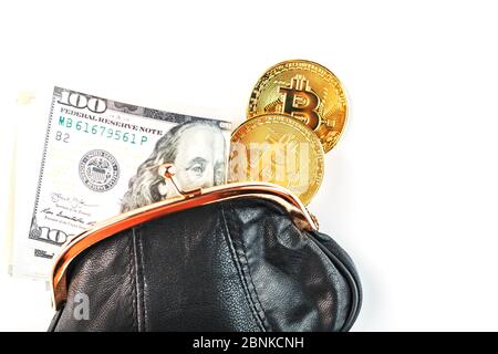 An open black wallet with money, dollars and bitcoin coins on a white background. Isolate, view, Studio light. Free space. Stock Photo