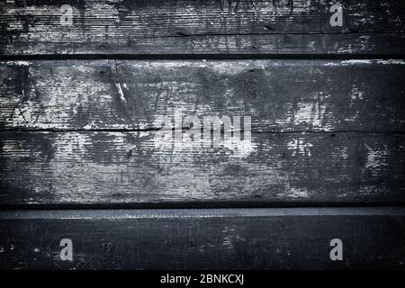 Rough wooden painted floor boards surface. Shabby wood texture covered by aged cracked painting. Distressed pattern. Damaged grey backdrop. Old villag Stock Photo