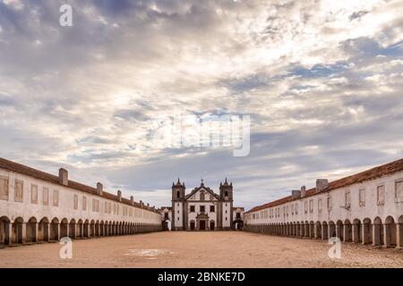 The Nossa Senhora do Cabo, Cabo Espichel, Sesimbra, Setubal peninsula, with its archs leading to the main building, on a cloudy day with sun shining Stock Photo