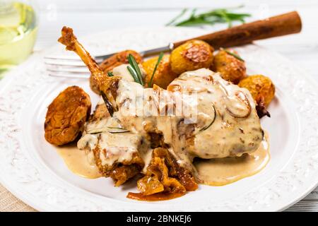 Fried Rabbit Meat With Rosemary in Sour Cream Sauce and Potato Stock Photo