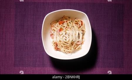SPAGHETTI AGLIO OLIO E PEPERONCINO IN A WHITE BOWL Stock Photo