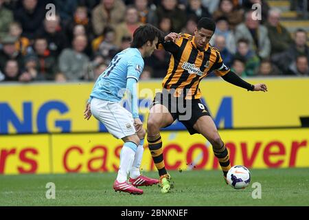 KINGSTON UPON HULL, ENGLAND - Curtis Davies of Hull City in action with Manchester City's David Silva during the Premier League match between Hull City and Manchester City at the KC Stadium, Kingston upon Hull on Saturday 15th March 2014 (Credit: Mark Fletcher | MI News) Stock Photo
