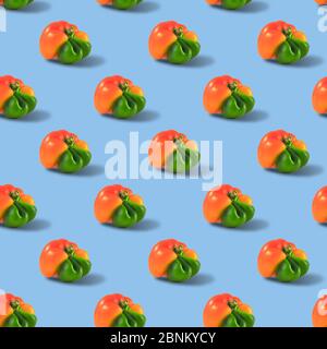 Ugly orange pepper seamless pattern peppers on a blue background. Stock Photo
