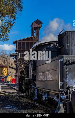 Steam locomotive building steam for work hauling passengers, at the Chama Station of the Cumbres & Toltec Scenic Railroad in Chama, New Mexico, USA Stock Photo