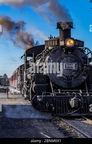 Steam locomotive building steam for work hauling passengers, at the Chama Station of the Cumbres & Toltec Scenic Railroad in Chama, New Mexico, USA Stock Photo