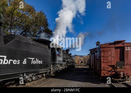 Steam locomotive building steam for work hauling passengers, at the Chama Station of the Cumbres & Toltec Scenic Railroad in Chama, New Mexico, USA Stock Photo