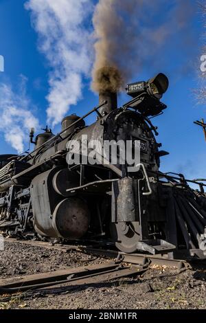 Steam locomotive building steam for work hauling passengers, at the Chama Station of the Cumbres & Toltec Scenic Railroad in Chama, New Mexico, USA Stock Photo