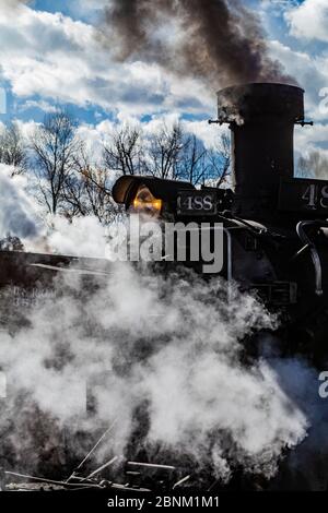 Steam locomotive building steam for work hauling passengers, at the Chama Station of the Cumbres & Toltec Scenic Railroad in Chama, New Mexico, USA Stock Photo