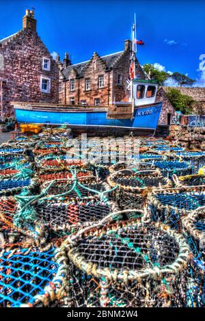 Town of Crail, Scotland. Artistic view of Crail quayside with lobster pots in the foreground and harbour residences in the background. Stock Photo