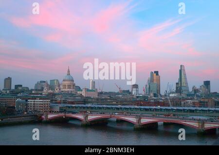 View over Southwark Bridge at Sunset including St Pauls Cathedral and Tower 42, London, England, UK, March 2014. Stock Photo