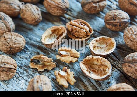 Walnuts, closed, open, supervision, wooden board Stock Photo