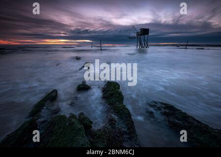 Traditional carrelet fishing hut at dusk with lift net on the beach at Saint-Michel-Chef-Chef, Loire-Atlantique, France September 2016 Stock Photo