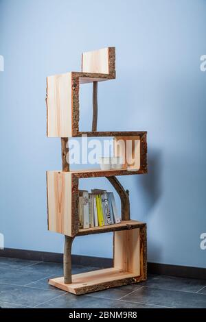 Construction of a wooden shelf, do-it-yourself production, final photo 05 in front of a light blue wall Stock Photo