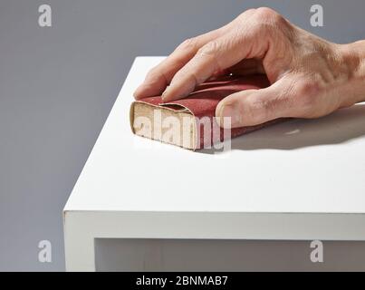 Construction of a shelf made of wood, Euro pallet, solid wood, MDF board; Do-it-yourself production, step-by-step, step 13 intermediate sanding with sanding block Stock Photo