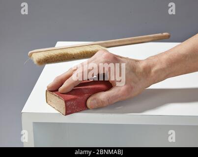 Construction of a shelf made of wood, Euro pallet, solid wood, MDF board; Do-it-yourself production, step-by-step, step 13b intermediate sanding with sanding block, then dedusting again Stock Photo