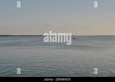 Small boat sailing on the lake in summer. Colors of summer Stock Photo