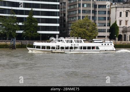 A white cruise boat in The River Thames, London, England, UK on the 8th of September 2018 Stock Photo